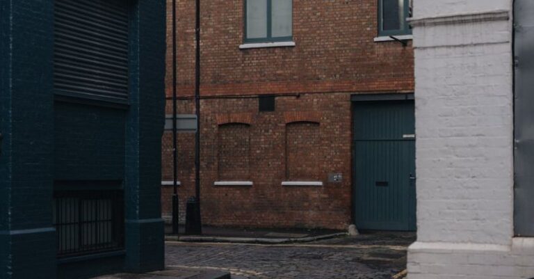 Turns - A narrow street with buildings and a brick wall