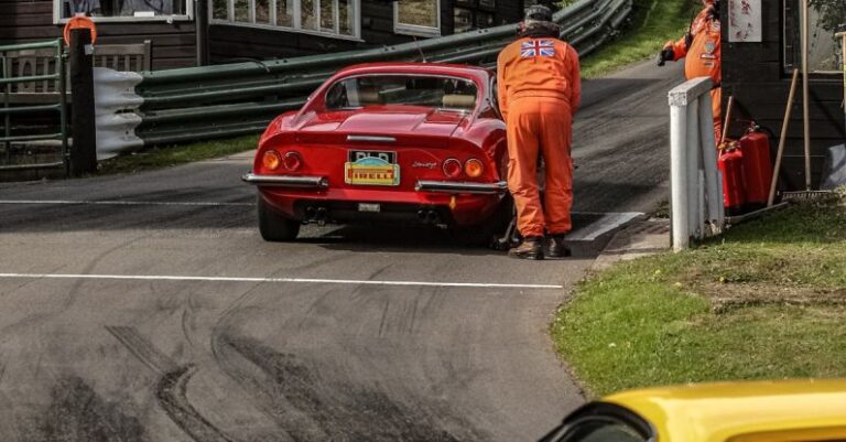 Races - Yellow and Red Car on a Racing Track an Men Wearing Orange Uniforms