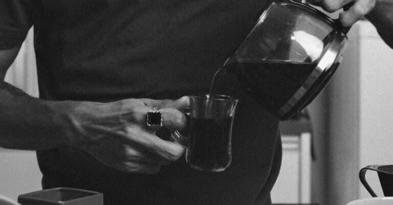 Routines - A man pouring coffee into a cup in front of a table